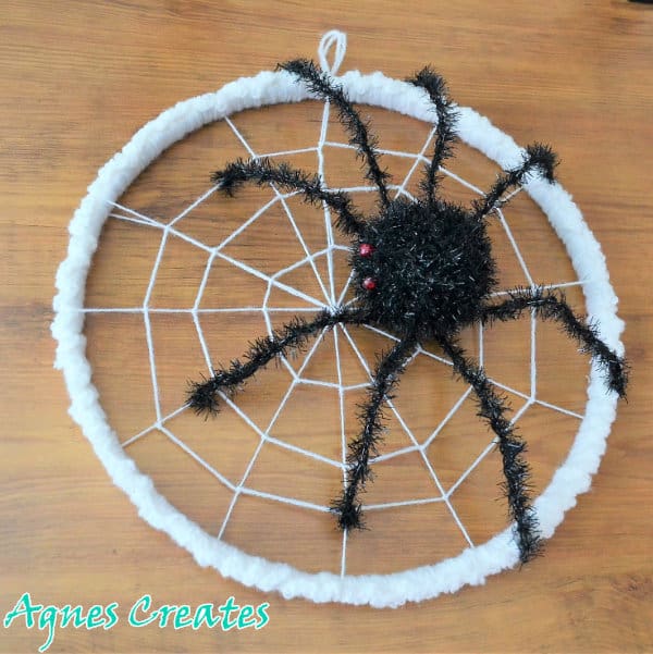 Learn how to crochet spiderweb wreath to decorate your front door for Halloween! Includes free spider crochet pattern!